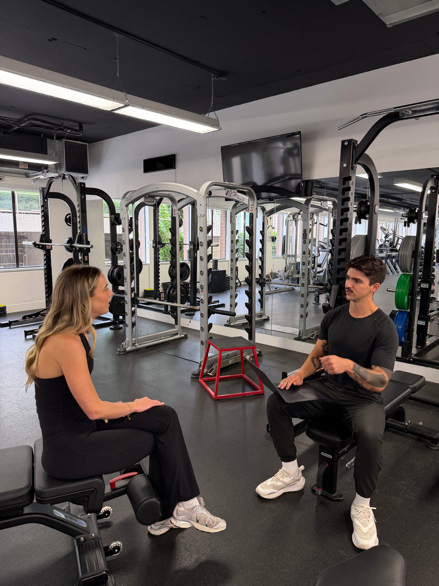 Paris Demers coaching a client through a strength exercise